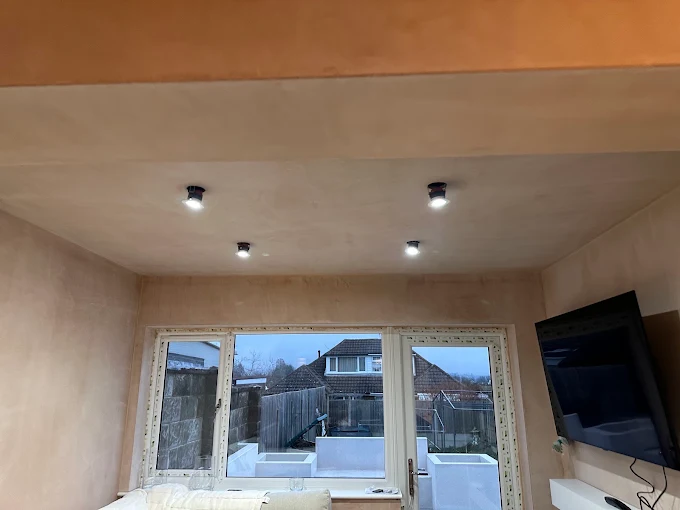 Living room extension ceiling with black surface-mounted spotlights fitted in a Kent home