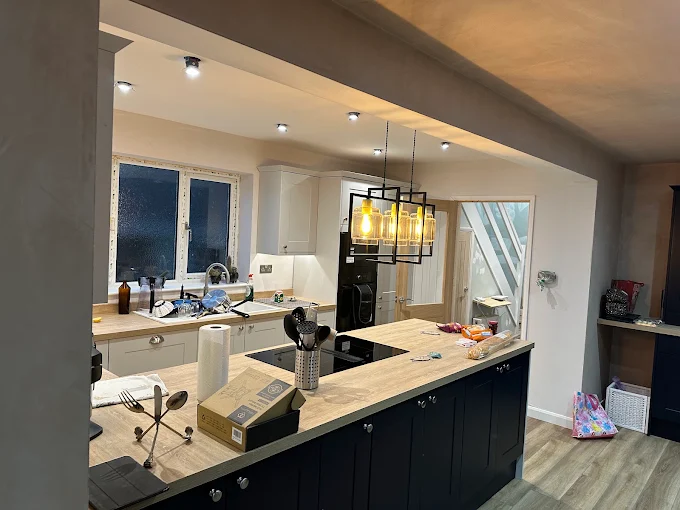 Open-plan kitchen in Maidstone with new LED downlights and pendant lighting installed by JM Electrical